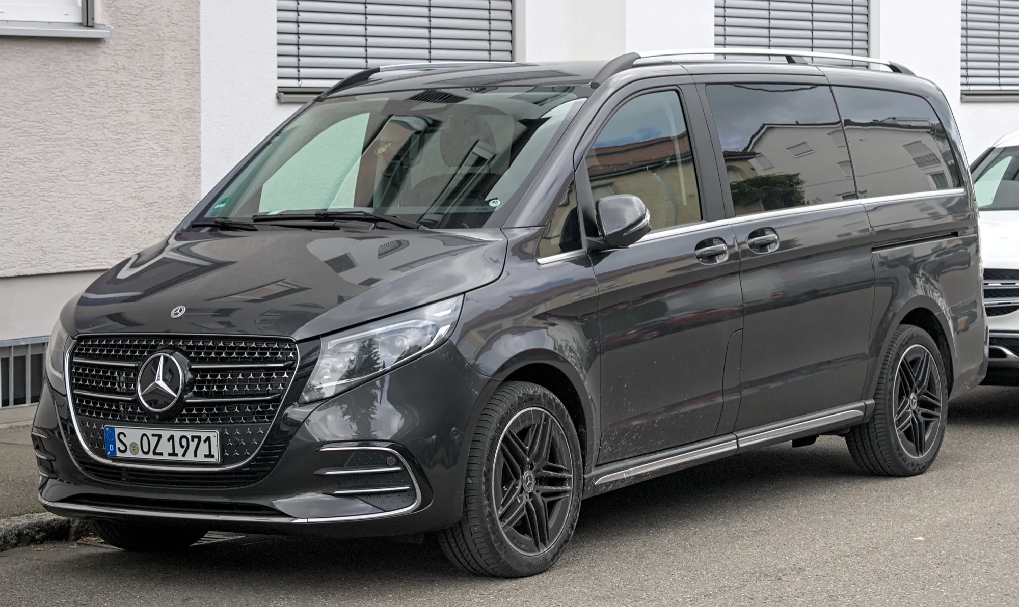 A dark grey Mercedes-Benz V-Class van parked at the kerb