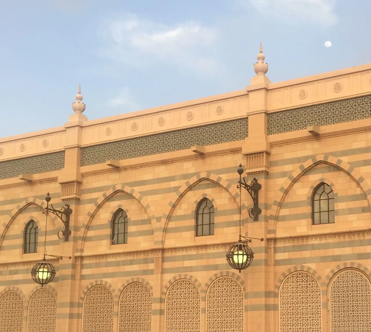 The striped sandstone facade and arched windows of the Sharjah Museum of Islamic Civilization