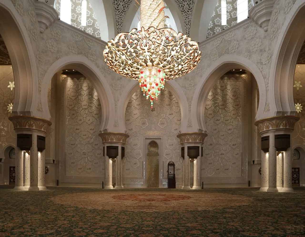 The main prayer hall of the Sheikh Zayed Grand Mosque, with a gold and crystal chandelier above the carpet