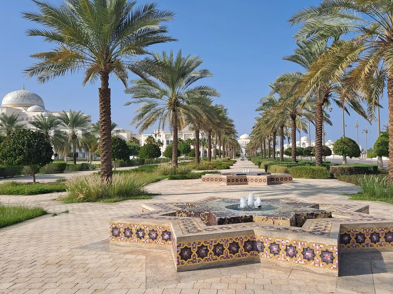 Palm-lined gardens and a tiled star-shaped fountain in the grounds of Qasr Al Watan, Abu Dhabi