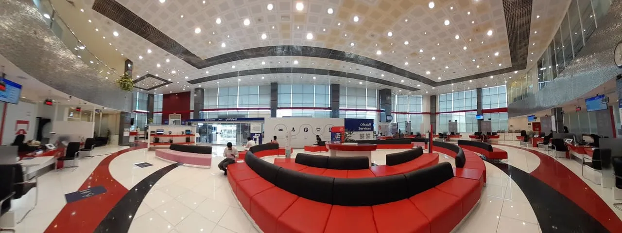 The customer service hall at an RTA centre in Dubai, with red seating and service counters