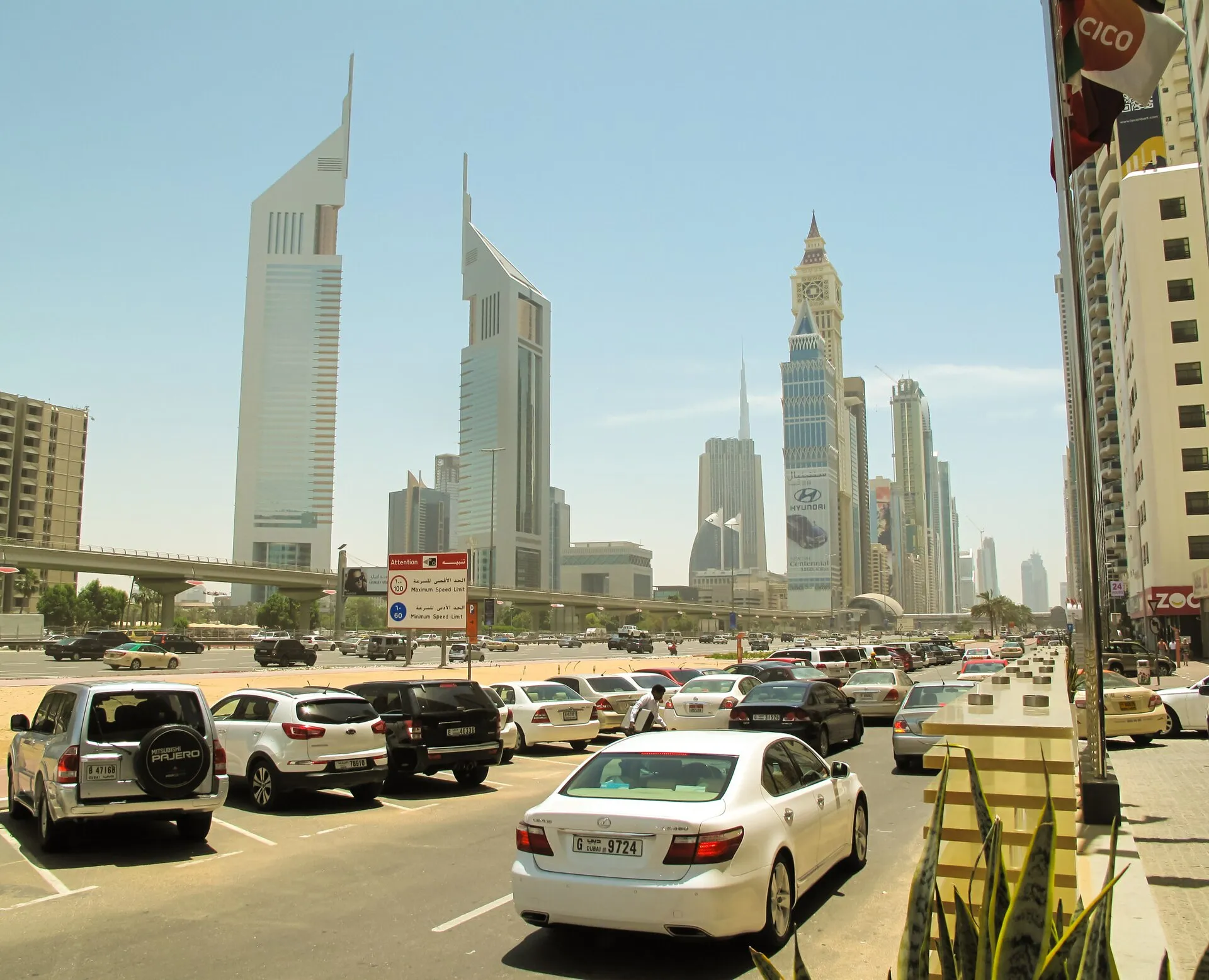Cars beside Sheikh Zayed Road in Dubai, with the Emirates Towers behind