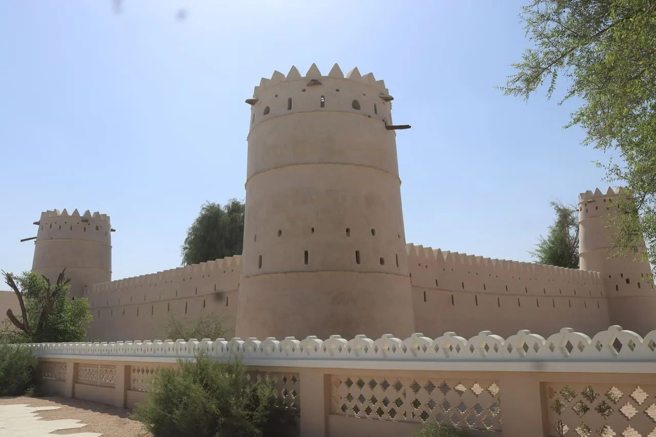 The round tower and crenellated walls of the Sultan bin Zayed Fort, beside Al Ain Museum