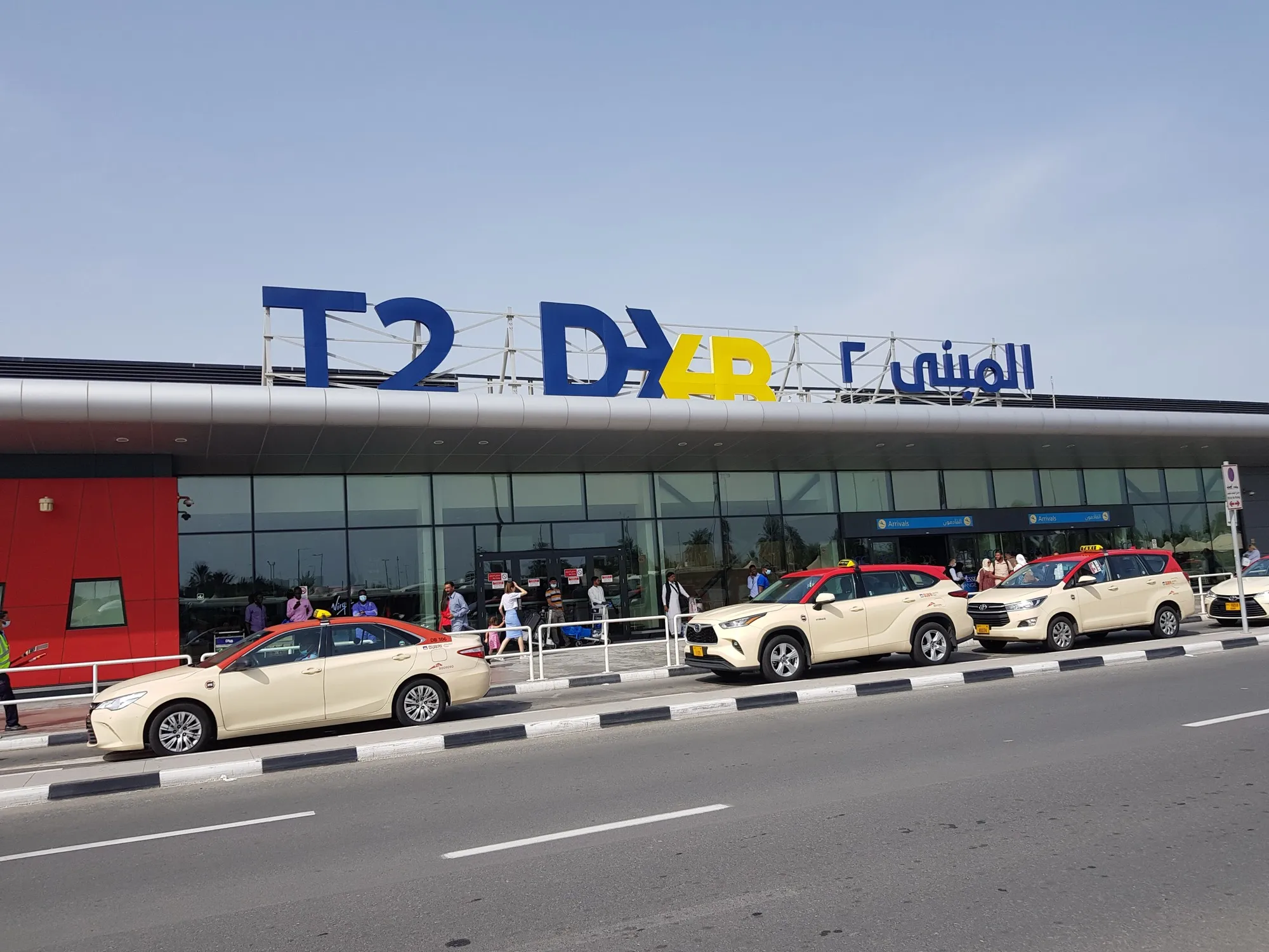 The Terminal 2 entrance at Dubai International Airport with taxis at the kerb