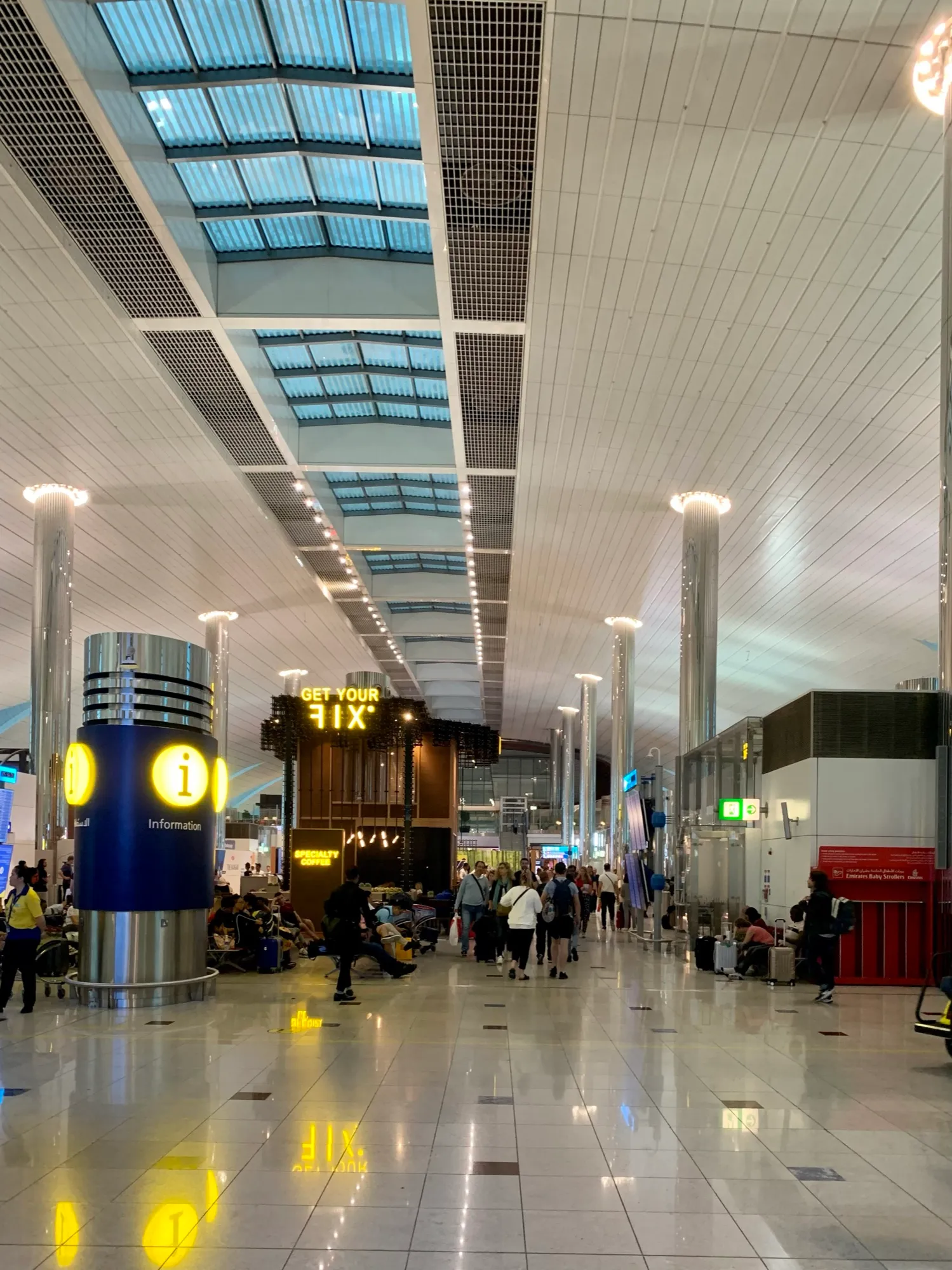 Information point and shops along a Terminal 3 concourse at Dubai International