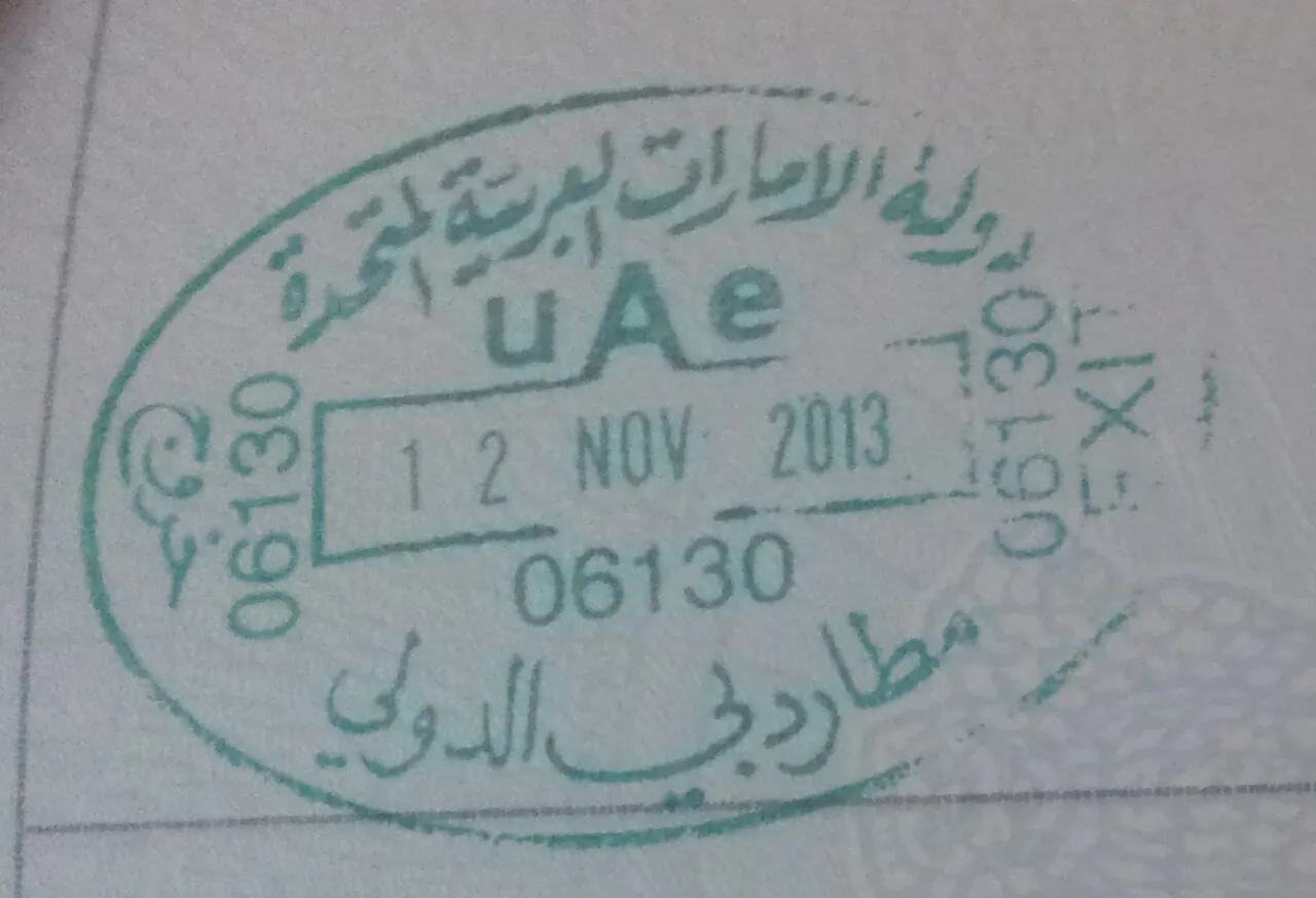 A UAE exit stamp from Dubai International Airport in a passport, dated 12 November 2013