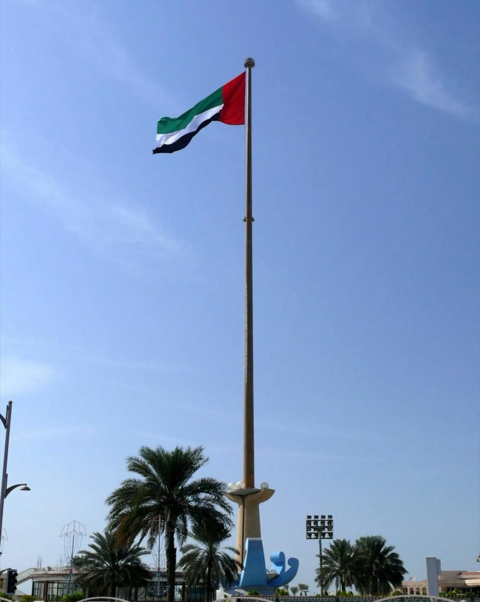 The UAE flag flying from the tall flagpole at Union House in Dubai on National Day