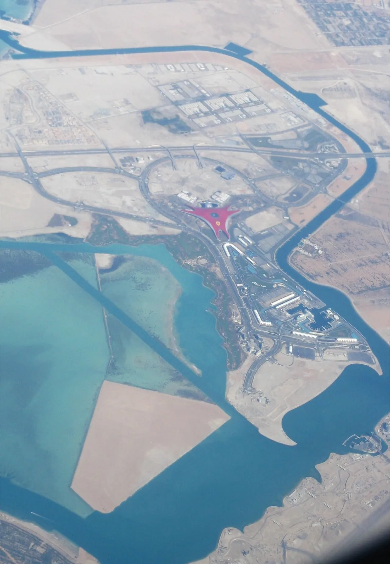 Yas Island seen from a plane, with the red roof of Ferrari World near its centre